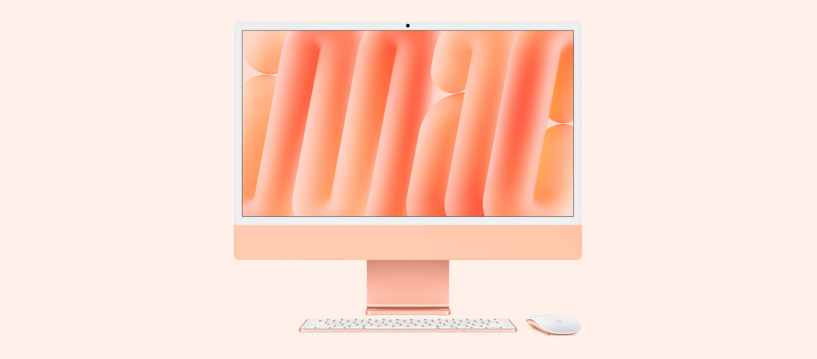 Vista frontal de un iMac naranja con mouse y teclado a juego