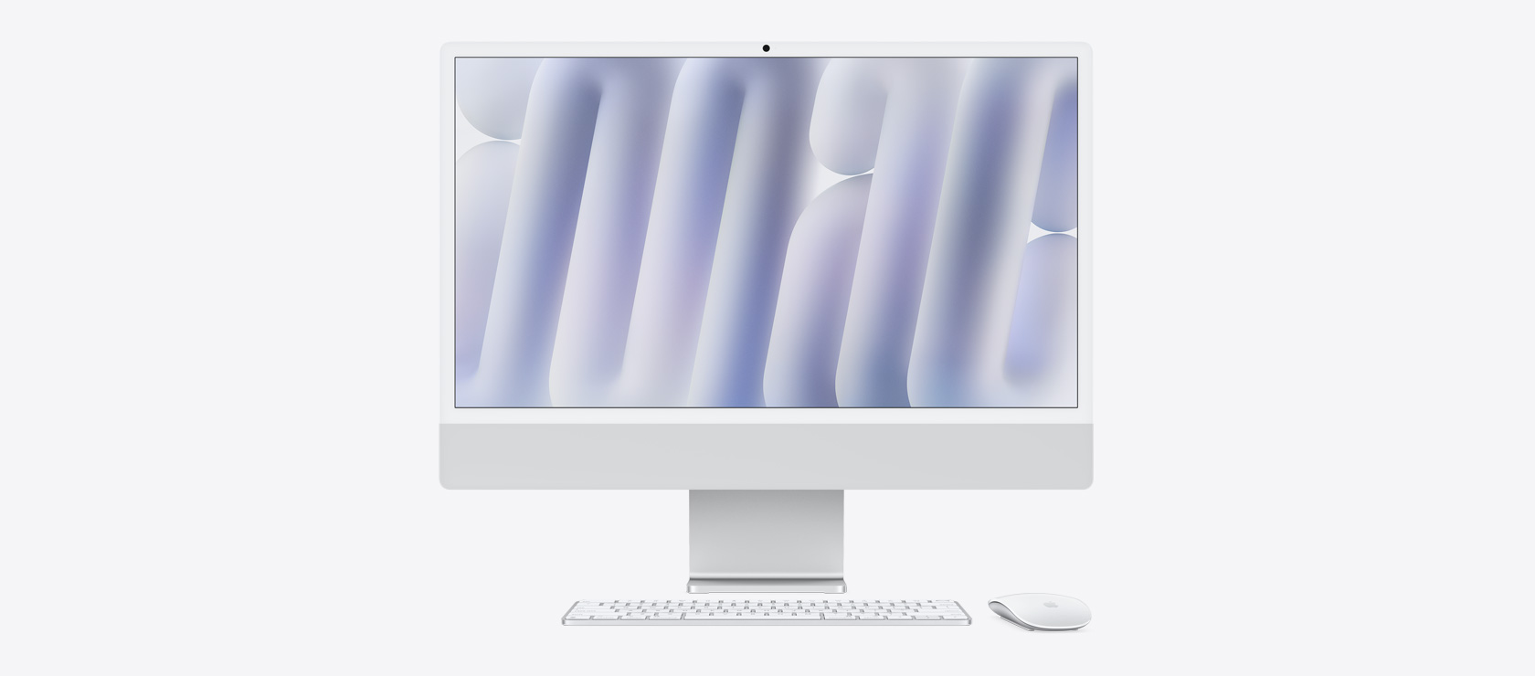 Vista frontal de un iMac color plata con mouse y teclado a juego